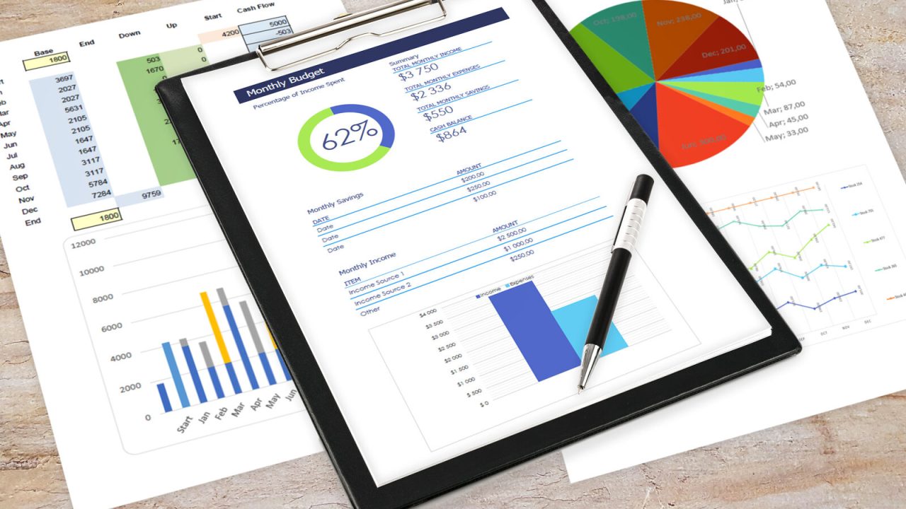 Printed analytics reports and a clipboard on a desk