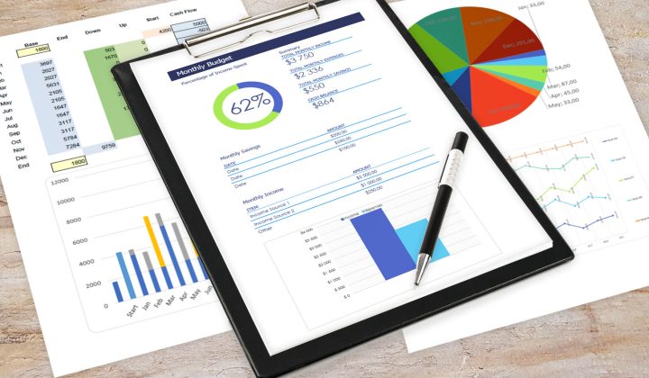 Printed analytics reports and a clipboard on a desk